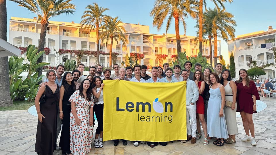 Lemon Learning team holding the brand flag
